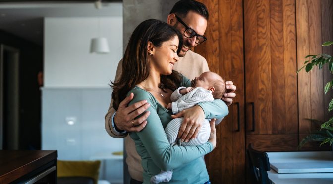 Two parents and their baby benefitting from MN Paid Leave.